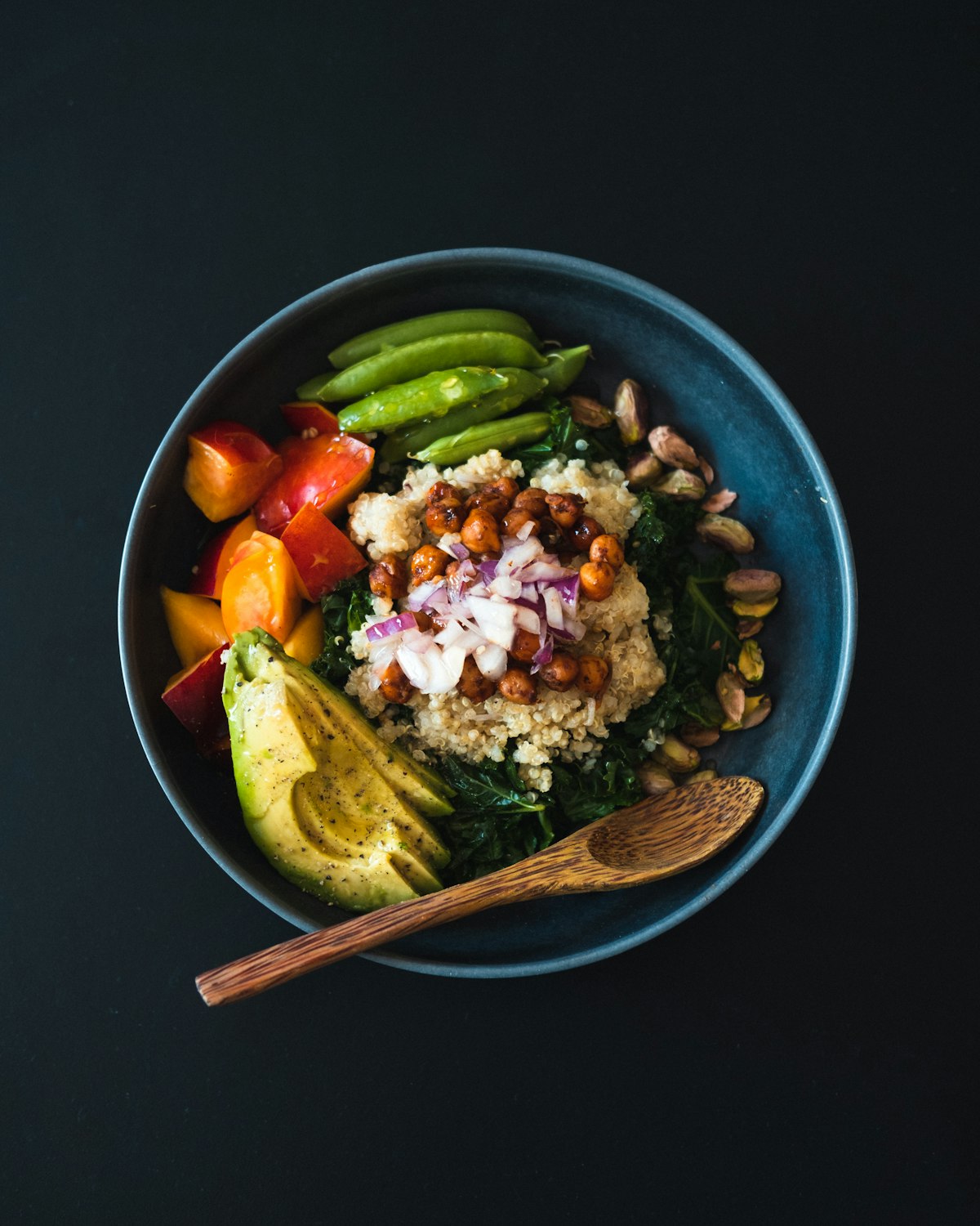 A quinoa and chickpea bowl with avocado and vegetables